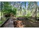 Outdoor kitchen with brick and wood features set amidst lush trees and vegetation, offering a unique outdoor space at 538 Murray St, Osteen, FL 32764