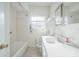 Bathroom featuring tub with shower, toilet, vanity, mirror and small window at 5527 Sandalwood Dr, Orlando, FL 32839