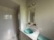 Tiled bathroom featuring a shower and a vanity with a turquoise sink and built-in shelves at 5527 Sandalwood Dr, Orlando, FL 32839