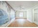 Bedroom featuring a scenic mural wall, wood flooring, and access to an adjacent bathroom, creating a serene retreat at 5527 Sandalwood Dr, Orlando, FL 32839