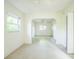 Bedroom featuring an archway, tile flooring, and natural light, creating a bright and airy space at 5527 Sandalwood Dr, Orlando, FL 32839