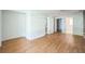 Spacious bedroom featuring wood floors, multiple doorways, and a ceiling fan at 5527 Sandalwood Dr, Orlando, FL 32839