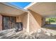 Side view of covered carport with gate, block wall, and view of trees at 5527 Sandalwood Dr, Orlando, FL 32839