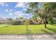Charming single-story home with arched entryway and a well-maintained lawn on a sunny day at 5527 Sandalwood Dr, Orlando, FL 32839