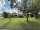 Charming home with a well-manicured lawn and mature trees, offering a serene and inviting curb appeal at 5527 Sandalwood Dr, Orlando, FL 32839