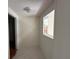 Hallway featuring tile flooring and a bright window that offers natural light at 5527 Sandalwood Dr, Orlando, FL 32839