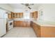 Bright kitchen features wood cabinets, white appliances, and a ceiling fan at 5527 Sandalwood Dr, Orlando, FL 32839