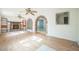Inviting living room with laminate floors, brick fireplace, built-in shelves, and archways at 5527 Sandalwood Dr, Orlando, FL 32839