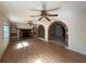 Bright living room featuring a fireplace, built-in shelves, hardwood floors and brick-trimmed openings at 5527 Sandalwood Dr, Orlando, FL 32839