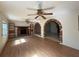 Bright living room featuring a fireplace, built-in shelves, hardwood floors and brick-trimmed openings at 5527 Sandalwood Dr, Orlando, FL 32839