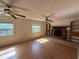 Inviting living room with wood floors, fireplace, built-in bookshelves, and lots of natural light at 5527 Sandalwood Dr, Orlando, FL 32839