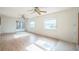 Living room with two ceiling fans, french doors, and large windows, and wood floors at 5527 Sandalwood Dr, Orlando, FL 32839