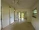 Bright living room with neutral walls, ceiling fan, and view into another area through an archway at 5527 Sandalwood Dr, Orlando, FL 32839