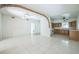 Bright open-concept living space featuring tile flooring and access to kitchen with beautiful wood cabinets at 5527 Sandalwood Dr, Orlando, FL 32839