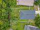 Aerial view of backyard, home, and the surrounding neighborhood with lush tree canopy at 5852 Stafford Springs Trl, Orlando, FL 32829