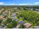 Wide aerial shot showcases a neighborhood with mature trees and beautiful sunny skies at 5852 Stafford Springs Trl, Orlando, FL 32829