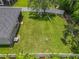 Aerial view of backyard with lush green lawn, chairs, and a white privacy fence at 5852 Stafford Springs Trl, Orlando, FL 32829