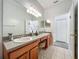 Spacious bathroom featuring double sinks, a vanity area, and white tile floors at 5852 Stafford Springs Trl, Orlando, FL 32829