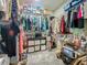 Walk-in closet providing ample storage space with multiple rows of shelving and hanging racks at 5852 Stafford Springs Trl, Orlando, FL 32829