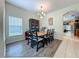 Bright dining room with wood table, black chairs, and a stylish chandelier at 5852 Stafford Springs Trl, Orlando, FL 32829