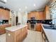 Well-equipped kitchen with center island, wood cabinets, and recessed lighting at 5852 Stafford Springs Trl, Orlando, FL 32829