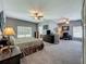 Expansive main bedroom featuring a sitting area, two ceiling fans, and neutral décor at 5852 Stafford Springs Trl, Orlando, FL 32829