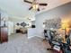 Open-concept main bedroom with dedicated office space and plush neutral carpeting at 5852 Stafford Springs Trl, Orlando, FL 32829