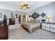 Main bedroom featuring a decorative wall, plush carpeting, and ample closet space at 5852 Stafford Springs Trl, Orlando, FL 32829