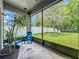 Screened-in patio with outdoor seating, overlooking a spacious backyard with lush greenery at 5852 Stafford Springs Trl, Orlando, FL 32829