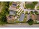This aerial view of the neighborhood shows many single Gathering homes and mature trees at 603 Cypress Tree Ct, Orlando, FL 32825