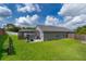 This backyard features a screened in in-ground pool and a well-manicured lawn at 603 Cypress Tree Ct, Orlando, FL 32825