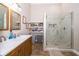 Bathroom featuring double sinks, a walk-in shower, shelves, and modern fixtures at 603 Cypress Tree Ct, Orlando, FL 32825