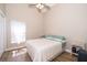 Guest bedroom with neutral decor, wood-look flooring, ceiling fan, and natural light at 603 Cypress Tree Ct, Orlando, FL 32825