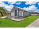 Charming single Gathering home featuring a blue door, landscaped front yard and a two car garage at 603 Cypress Tree Ct, Orlando, FL 32825