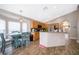 Open kitchen and dining area with wood-look tile flooring and modern appliances at 603 Cypress Tree Ct, Orlando, FL 32825