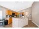 Charming kitchen with a central island, granite countertops, and wood-look tile floors at 603 Cypress Tree Ct, Orlando, FL 32825