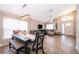 Open-concept living and dining room with a large window, wood floors, and modern decor at 603 Cypress Tree Ct, Orlando, FL 32825