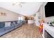 Open concept living room and kitchen with wood-look tile and vaulted ceilings at 603 Cypress Tree Ct, Orlando, FL 32825