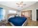 Comfortable main bedroom featuring vaulted ceilings, wood-look floors, and a ceiling fan at 603 Cypress Tree Ct, Orlando, FL 32825