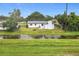 An aerial shot of the back of the property showcasing the grassy yard, exterior features and peaceful surroundings at 609 Brockway Ave, Orlando, FL 32807
