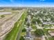 An aerial view showcases a quiet neighborhood with tree-lined streets and a nearby pond area at 609 Brockway Ave, Orlando, FL 32807