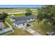 Aerial showing the home, newly renovated exterior, a driveway, and a well-maintained lawn at 609 Brockway Ave, Orlando, FL 32807