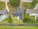Aerial view of the L-shaped home with a dark gray roof, green yard and a small patio in the backyard at 609 Brockway Ave, Orlando, FL 32807