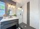 Updated bathroom with modern vanity and frameless glass shower at 609 Brockway Ave, Orlando, FL 32807