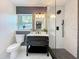 Updated bathroom with modern vanity and frameless glass shower at 609 Brockway Ave, Orlando, FL 32807