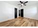 This bedroom features wood-look floors, fresh white paint, two closets, and dark trim and doors at 609 Brockway Ave, Orlando, FL 32807