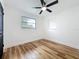 This bedroom features wood-look floors, fresh white paint, and dark trim and door at 609 Brockway Ave, Orlando, FL 32807
