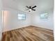 Bright bedroom with wood-look floors, fresh white paint and modern ceiling fan at 609 Brockway Ave, Orlando, FL 32807