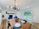 Bright dining room featuring modern lighting, dining table and chairs, and a sliding glass door at 609 Brockway Ave, Orlando, FL 32807