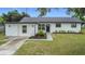 Charming single-story home featuring a freshly painted exterior, new landscaping, and a welcoming front entrance at 609 Brockway Ave, Orlando, FL 32807